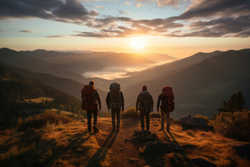 group of hikers tourists stand on the mountain and look at the dawn