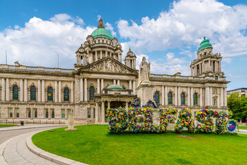 Front view of Belfast City Hall with flowers decorating the word "Belfast" at Donegall Square, Northern Ireland, UK