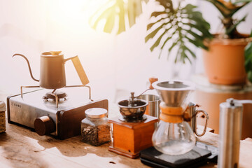 Happy young adult couple making breakfast and drinking coffee together in cozy home kitchen in morning at home. Preparing meal and smiling. Lifestyle, leisure and Love concept.