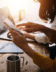 Entrepreneur Asian businessman and businesswoman discussing new business project in tablet in modern Meeting In Modern Office, Asian business casual concept.