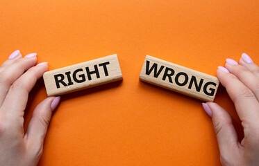 Right or Wrong symbol. Concept word Right or Wrong on wooden blocks. Businessman hand. Beautiful...