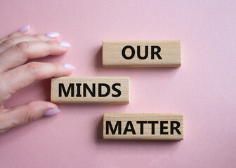 Our Minds Matter symbol. Concept words Our Minds Matter on wooden blocks. Doctor hand. Beautiful pink background. Psychological social and Our Minds Matter concept. Copy space.