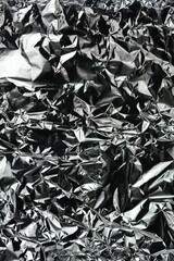 Aluminum foil background with shiny crumpled surface for texture background