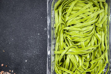 green pasta raw tagliatelle color basil vegetable food meal food snack on the table copy space food background rustic top view