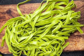 green pasta raw tagliatelle color basil vegetable food meal food snack on the table copy space food background rustic top view