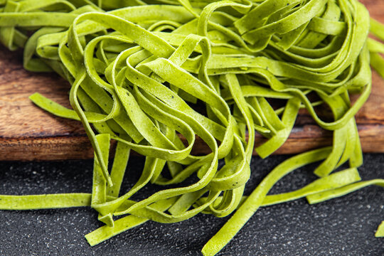 green pasta raw tagliatelle color basil vegetable food meal food snack on the table copy space food background rustic top view