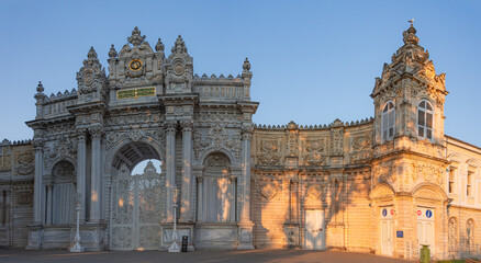 Fototapeta na wymiar Sunset shot of closed gate leading to former Ottoman Dolmabahce Palace, or Dolmabahce Sarayi, suited in Ciragan Street, Besiktas district, Istanbul, Turkey. Panorama, panoramic view