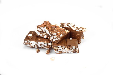 Chunks of milk chocolate with puffed rice isolated on white background. Rice chocolate studio isolated. 