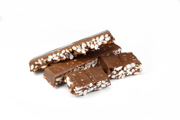 Chunks of milk chocolate with puffed rice isolated on white background. Rice chocolate studio isolated. 