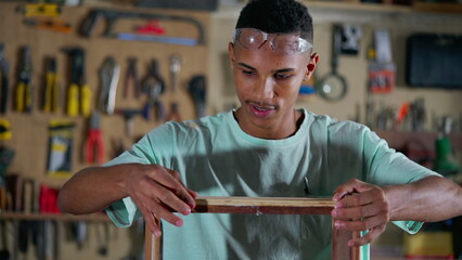 Young Black Apprentice at Furniture Building Workshop, Craftsmanship Occupation, A Brazilian worker at carpentry store