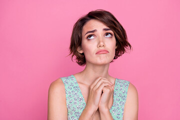 Closeup photo of beautiful young lady hands together miserable frustrated offended reaction look above isolated on pink color background