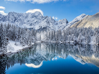 Magic and emotions of the Fusine lakes after the snowfall. Winter dress magic. Tarvisio. Top view - 639018909