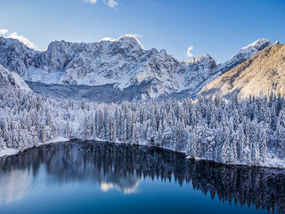 Magic and emotions of the Fusine lakes after the snowfall. Winter dress magic. Tarvisio. Top view