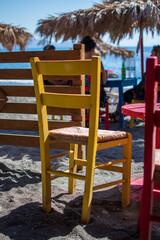 yellow colourful chair next to red one on beach lounge cafe restaurant 