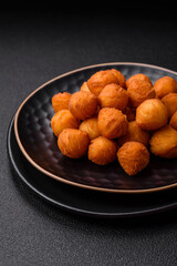 Delicious fried potato balls with breaded mozzarella, salt, spices and herbs