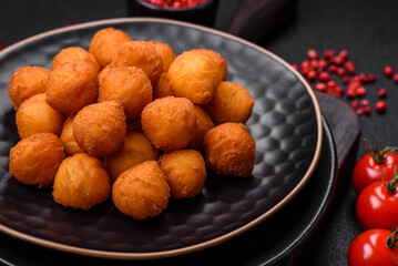 Delicious fried potato balls with breaded mozzarella, salt, spices and herbs