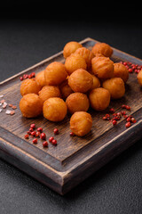 Delicious fried potato balls with breaded mozzarella, salt, spices and herbs