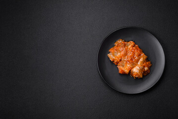 Delicious fresh sea fish cut into pieces and baked in tomato sauce