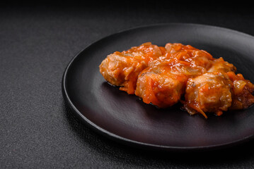 Delicious fresh sea fish cut into pieces and baked in tomato sauce