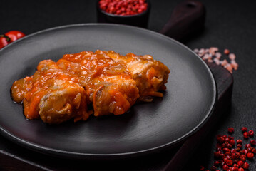 Delicious fresh sea fish cut into pieces and baked in tomato sauce