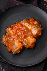 Delicious fresh sea fish cut into pieces and baked in tomato sauce