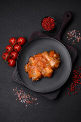 Delicious fresh sea fish cut into pieces and baked in tomato sauce