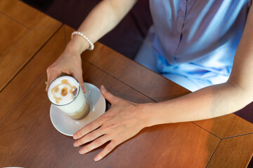 woman in cafe drinking coffee latte
