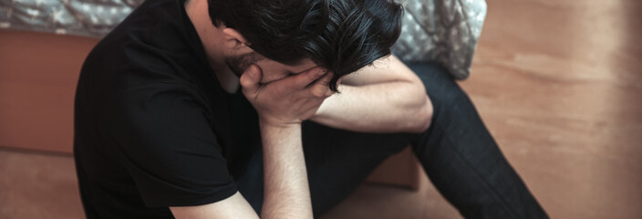sad man sitting in room