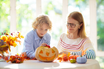 Family carving pumpkin for Halloween