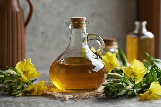 A jar of evening primrose oil with fresh flowers