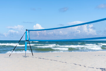 Beach volleyball and beach tennis net on the background of sand. Horizontal sport theme poster,...