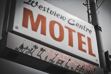 motel sign in black and white with orange accent