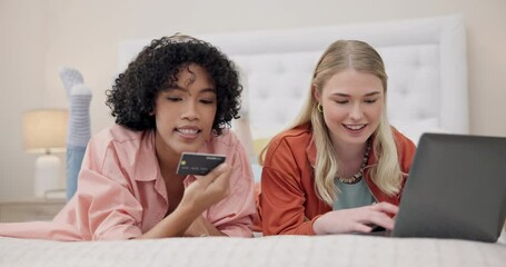 Women, credit card and friends with laptop on a bed for ecommerce, sale or sign up information in their home. Online shopping, payment and customer cashback in a bedroom for deal, budget or survey