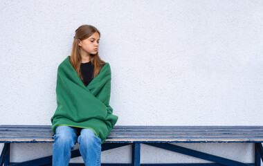 Portrait of a teenage girl looking at the camera. Young sad thinking curious child looks at the camera close-up. Face and eyes Serious contemplative child.