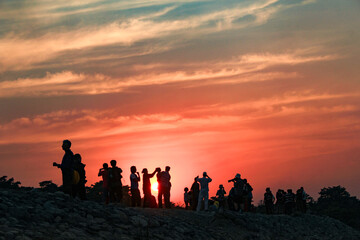 people enjoy the sunset at Chitwan. national park in Nepal