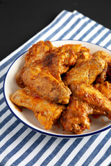 Homemade Rotisserie Chicken Wings with Smoked Paprika and Mayonnaise on a Plate, side view. Close-up.