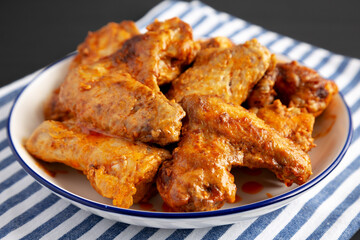 Homemade Rotisserie Chicken Wings with Smoked Paprika and Mayonnaise on a Plate, side view. Close-up.