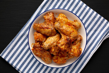 Homemade Rotisserie Chicken Wings with Smoked Paprika and Mayonnaise on a Plate, top view. Flat lay, overhead, from above.