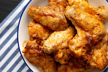 Homemade Rotisserie Chicken Wings with Smoked Paprika and Mayonnaise on a Plate, top view. Flat lay, overhead, from above. Close-up.