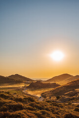 Romantic sunset view to Aegean Sea Lemnos or Limnos Island Greece, summer travel destination, bokeh light of car dust