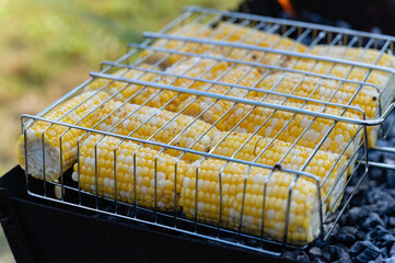 Fresh young corn is cooked on the grill.
