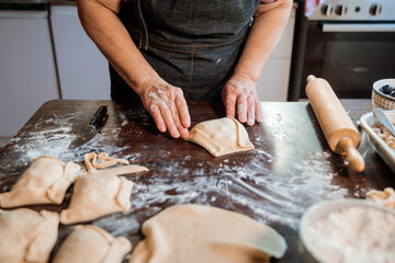 Latin Elderly Woman Crafting Flavorful Chilean Meat and Onion-filled Empanadas in her Countryside Home Kitchen