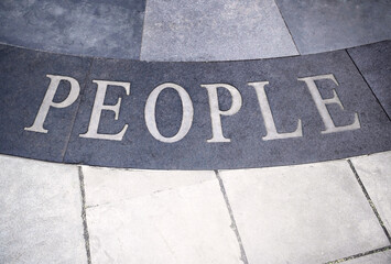 black and white people word signage on street pavement