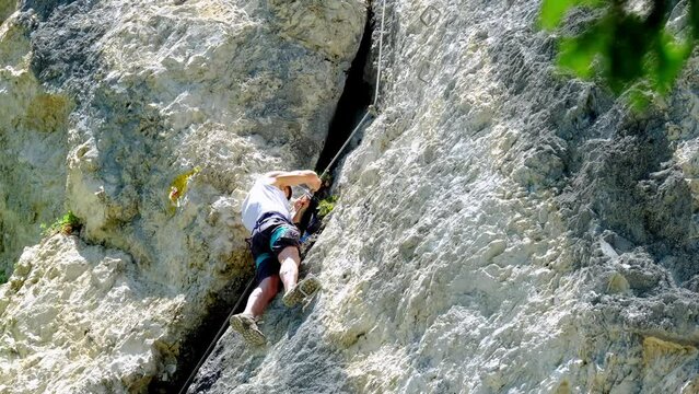 mature man, rock climber in body harnesses feature life-safety climbs in Seefeld in Tirol, extreme lifestyle of people, mountaineering, via ferrata in mountains, life insurance in extreme sports