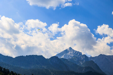 The Alpspitze in the Wetterstein mountains with paragliders seen from Garmisch-Partenkirchen on a...