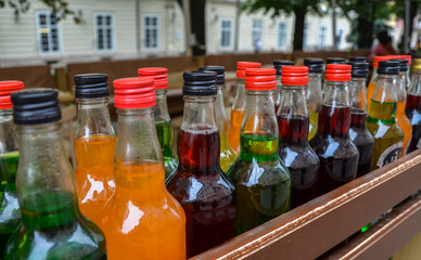Multi-colored liquors or tinctures in bottles for sale as a souvenir on the city street