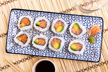 Appetizing sushi california roll with salmon and avocado