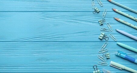 Set of school stationery on blue background with space for text