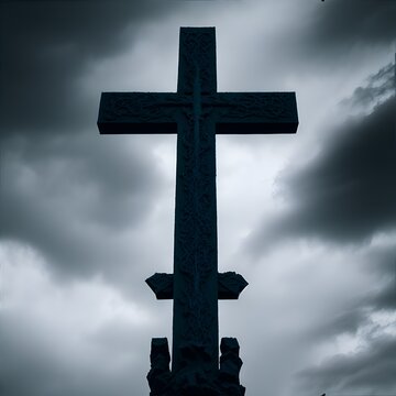 Photo of a towering cross against a dramatic cloudy sky