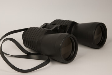 A pair of old black binoculars on a white background